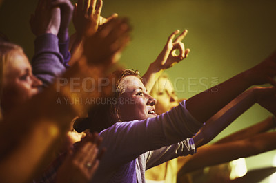 Buy stock photo Concert, fans and dance to music at night,, performance and audience with energy at festival. Crowd, support and people stretching hands in celebration or praise of rock, culture or excited at event