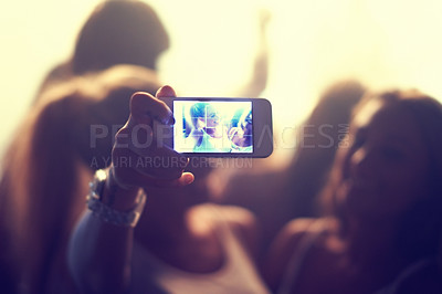 Buy stock photo Shot of a fan filming a concert on their camera