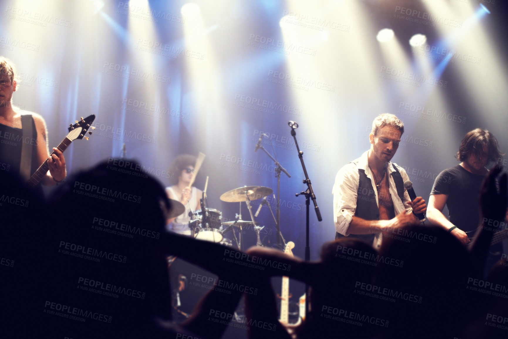 Buy stock photo Cropped shot of a guitarist on stage surrounded by adoring fans. This concert was created for the sole purpose of this photo shoot, featuring 300 models and 3 live bands. All people in this shoot are model released.