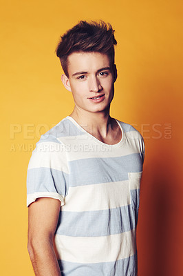 Buy stock photo Portrait, fashion and man with style, trendy and confident guy on an orange studio background. Face, person and model with casual outfit, sexy and stylish clothes with gen z, t shirt and aesthetic
