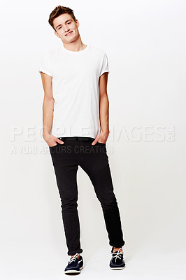 Buy stock photo Full length studio shot of young man standing with hands in pockets and smiling
