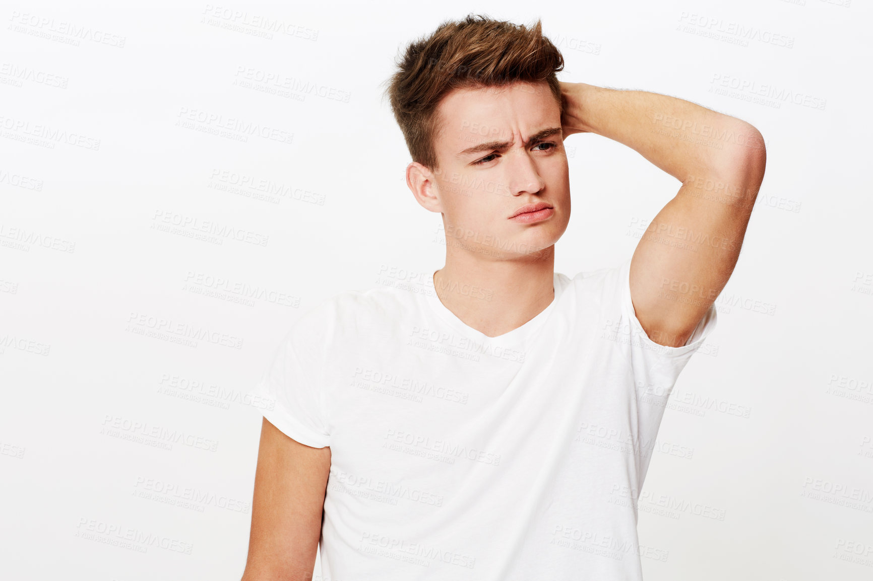 Buy stock photo Studio portrait of a young man with his arm up and a serious expression