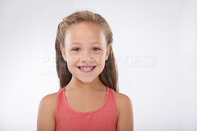 Buy stock photo Kid, girl and portrait or happiness in studio with confidence, positive attitude and carefree youth. Child, face and smile with calm expression, mock up space and casual outfit on white background