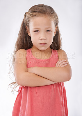 Buy stock photo Angry, girl and child in studio with arms crossed, frustrated in portrait and emotion, cross or upset on white background. Facial expression, rage and conflict with tantrum, furious and  bad attitude