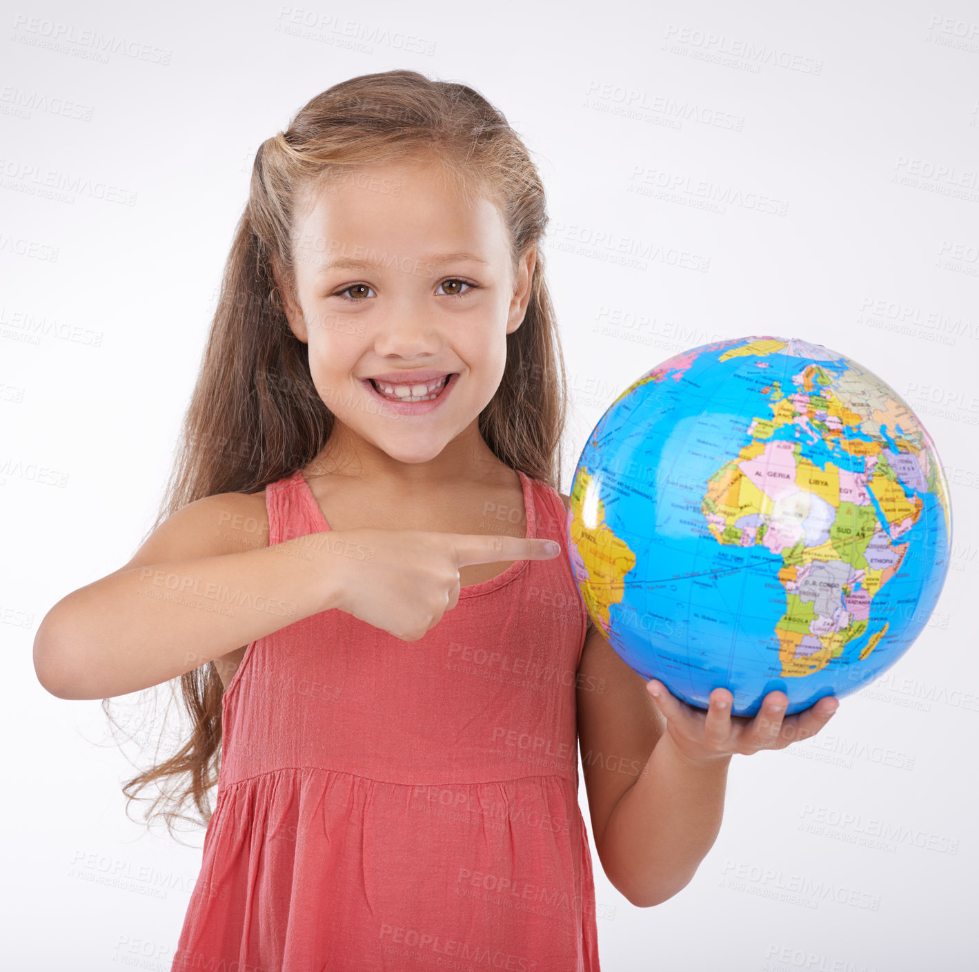 Buy stock photo Kid, pointing to globe in studio with world, planets and city for education, geography and portrait. Student, girl child and travel map with smile for earth day support or ecology on white background