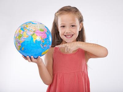 Buy stock photo Child, pointing to globe in studio with world, planets and city for education, geography and portrait. Student, girl kid and travel map with smile for earth day support or ecology on white background