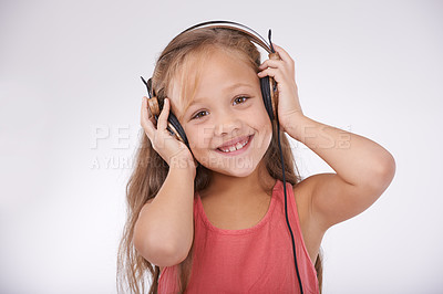 Buy stock photo Kid, music and portrait of girl with headphones in studio for audio, subscription and streaming multimedia on white background. Happy child listening to podcast, hearing sound and radio entertainment