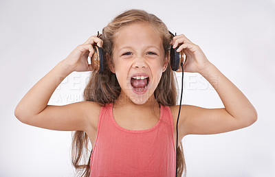 Buy stock photo Girl, headphones and screaming for noise in portrait, autism and sensory overstimulation in studio. Female person, kid and yelling for sound on white background, stress and frustration in childhood