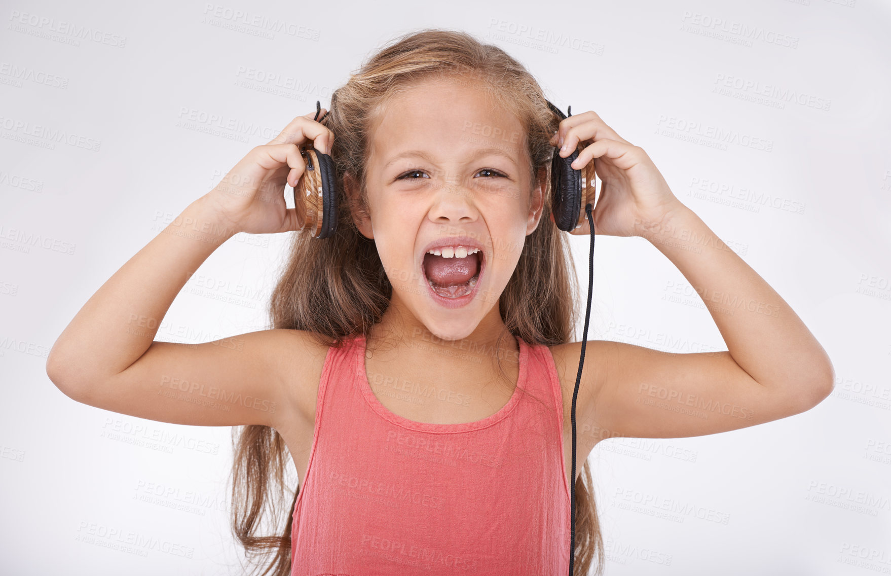 Buy stock photo Girl, headphones and screaming for noise in portrait, autism and sensory overstimulation in studio. Female person, kid and yelling for sound on white background, stress and frustration in childhood