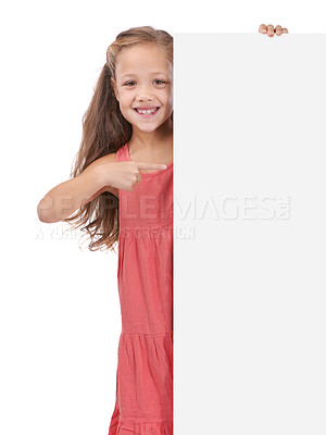 Buy stock photo Child, portrait and placard board or pointing in studio for announcement, information or white background. Female person, mockup space or news poster or bulletin review opinion, billboard or message