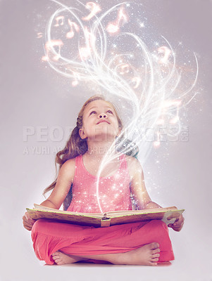 Buy stock photo Studio shot of a young girl reading a storybook