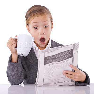 Buy stock photo Young child, reading and newspaper headlines in studio with shock for business, coffee and surprise of daily events. Little girl, suit or thinking by mug as pretend professional or white background