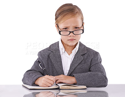 Buy stock photo Business person, notebook and child in portrait, writing ideas and planning tasks in studio. Serious female person, pretend employee and journal for notes, schedule and diary on white background