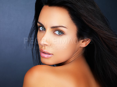 Buy stock photo Portrait, skincare and wellness with a young woman in studio on a blue background for makeup or cosmetics. Face, beauty and aesthetic with a confident model at the salon for luxury dermatology