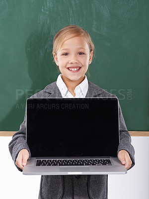 Buy stock photo Child, girl and laptop screen in classroom for education, online school and marketing space against a chalkboard. Happy student or kid in portrait with computer mockup for e learning presentation