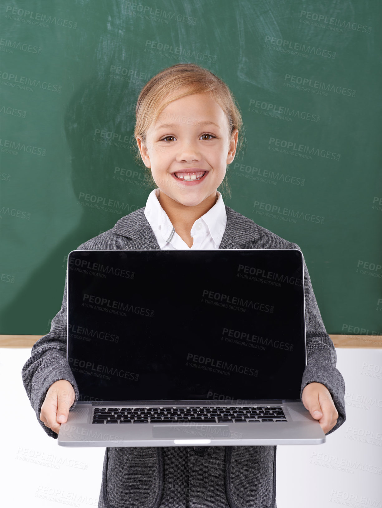 Buy stock photo Child, girl and laptop screen in classroom for education, online school and marketing space against a chalkboard. Happy student or kid in portrait with computer mockup for e learning presentation