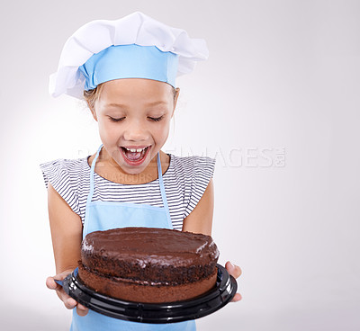 Buy stock photo Kid, baker and excited with cake, happy and confident with child development on white background. Culinary skills, satisfied and baking dessert and childhood with confidence in hospitality industry