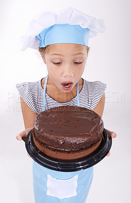 Buy stock photo Kid, baker and shocked with cake, happy and confident with child development on white background. Culinary skills, satisfied and baking dessert and childhood with confidence in hospitality industry