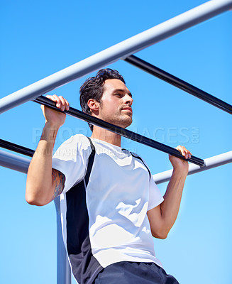 Buy stock photo A handsome young man working out outdoors