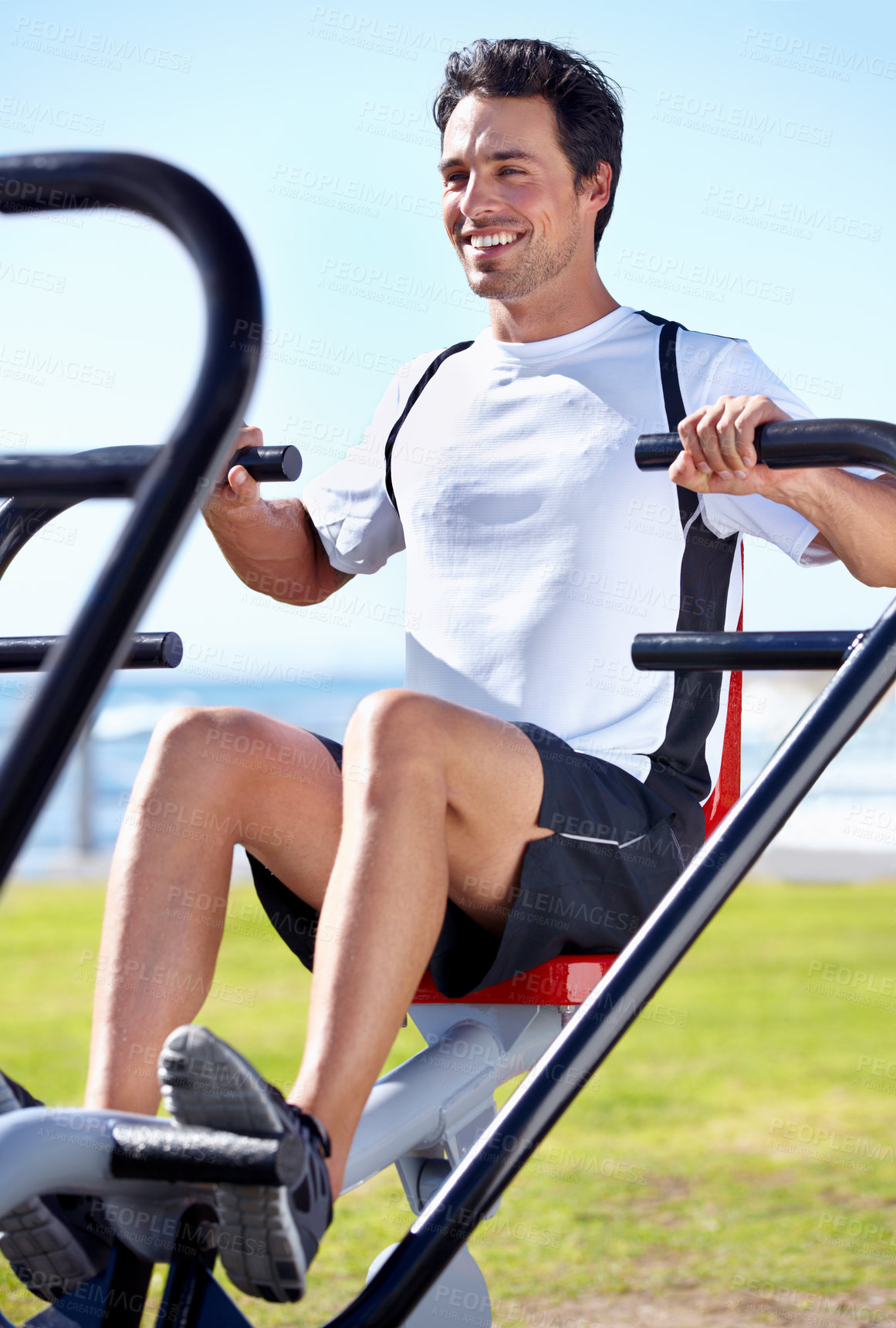 Buy stock photo Happy man, fitness and shoulder press on park equipment for gym workout, exercise or training in nature. Fit, active and strong male exercising on outdoor machine for muscle, chest or weightlifting