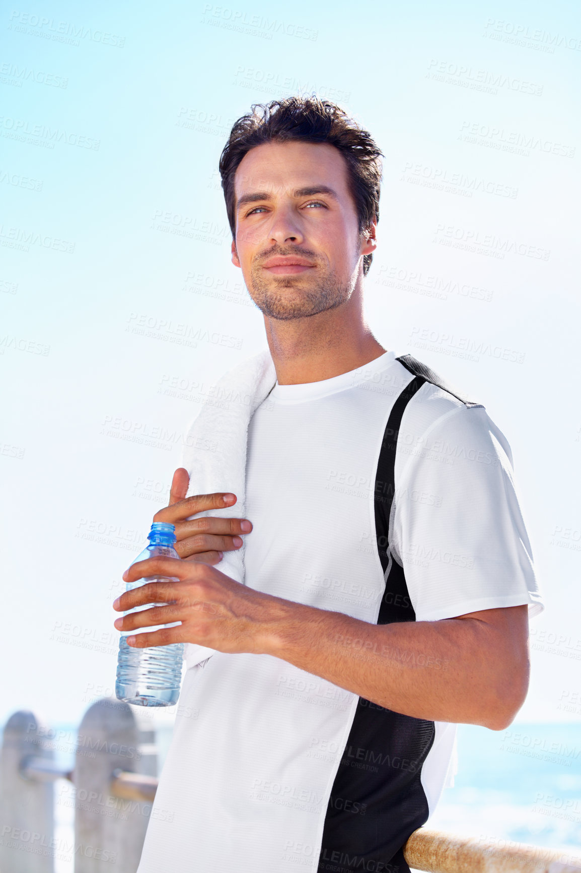 Buy stock photo Beach, thinking and man with water bottle, fitness and exercise with wellness and sunshine. Person, seaside and guy with liquid and ideas with nature, summer and workout with breathing and nutrition