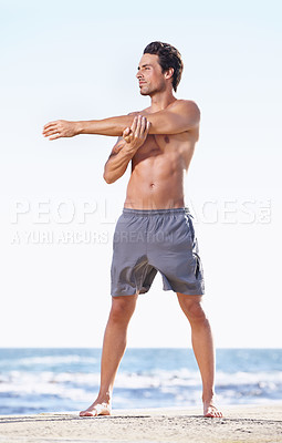 Buy stock photo Fitness, man and stretching arms on beach getting ready for body exercise, workout or training in nature. Fit, active or muscular male person in warm up arm stretch for cardio or exercising by ocean