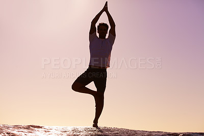 Buy stock photo Man, silhouette and yoga in sunset meditation on beach for spiritual wellness, inner peace or mental wellbeing in nature. Male yogi in tree pose for balance, healthy body or mindfulness on ocean rock