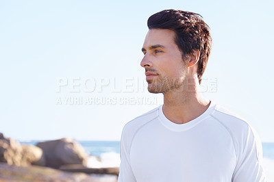 Buy stock photo Exercise, thinking and space with man at beach in summer for sports, training or cardio on blue sky. Fitness, vision and health with young runner or athlete by ocean or sea for physical workout
