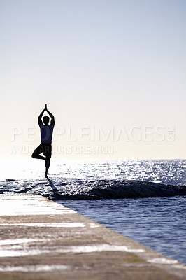 Buy stock photo Full-length concept shot of a young man standing on a wave