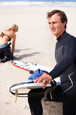 Buy stock photo Thinking, cleaning and man with surfboard on beach for sports, training or getting ready to workout. Summer, vision and wax with confident surfer on sand by ocean or sea for fitness and exercise