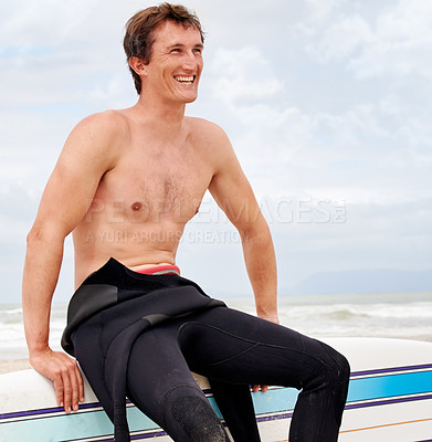 Buy stock photo Vision, smile and shirtless man with surfboard on beach in wetsuit for sports, travel or fitness. Nature, thinking and body of young surfer on sand by ocean or sea for exercise, training and workout