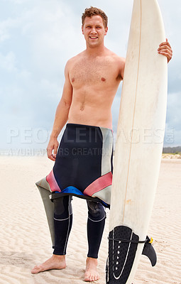 Buy stock photo Portrait, smile and shirtless man with surfboard on beach in wetsuit for sports, travel or fitness. Nature, sky and body of young surfer on sand by ocean or sea for exercise, training and workout