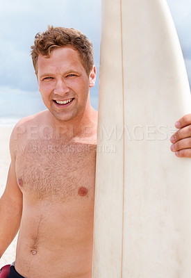 Buy stock photo Portrait, happy and shirtless man with surfboard at beach on blue sky for sports, travel or fitness. Nature, smile and body of young person by ocean or sea for surfing, exercise and training