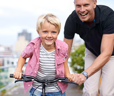 Buy stock photo Bicycle, portrait and father with boy child in a road for help, learning or outdoor ride together. Love, family or parent with kid in a street for cycling assistance, fun or bonding, support or care
