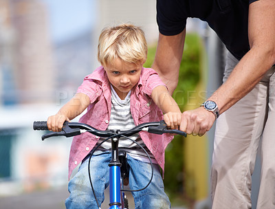 Buy stock photo Father, bike and teaching child to ride in outdoor, bonding together and wellness with childhood development. Parent, son and fun in nature for learning bicycle, love and care for cycling on vacation