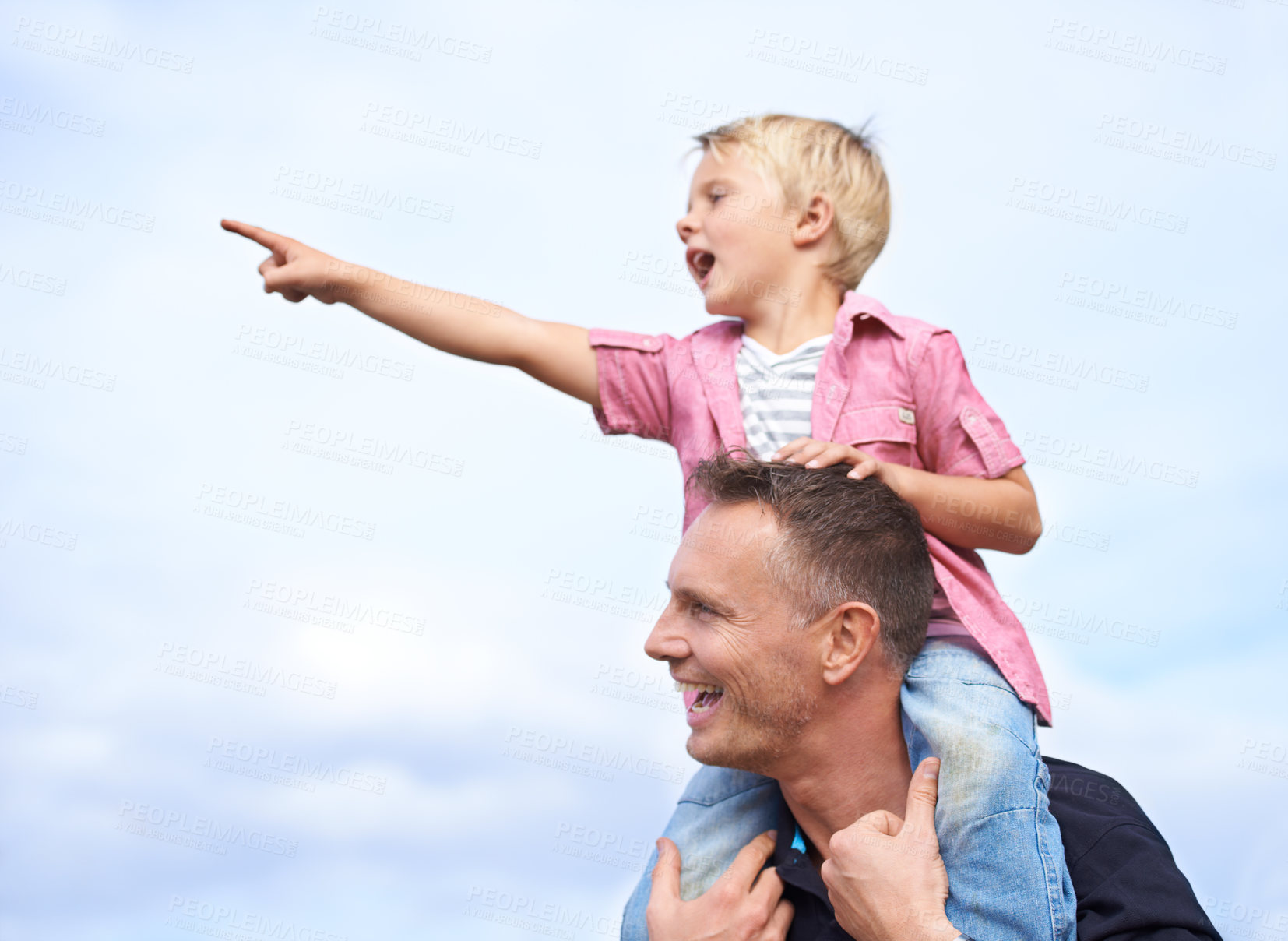 Buy stock photo Father, outdoor and carrying child on shoulders for childhood playing, sunshine and wellness by blue sky. Parent, son and pointing in nature for bonding together, love and fun on outside on vacation