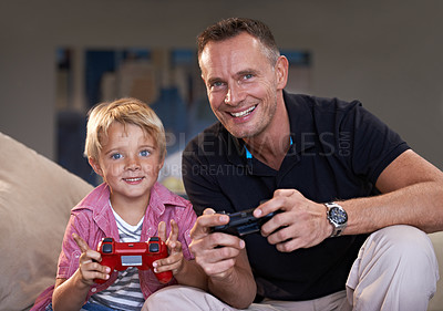 Buy stock photo Family, father and son gaming on sofa in living room of home together for love, competition or child development. Video game, controller and next level with man parent gamer teaching boy child