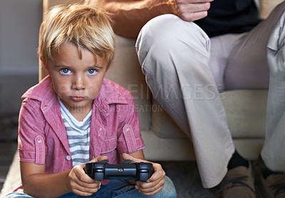 Buy stock photo A young boy playing video games at home