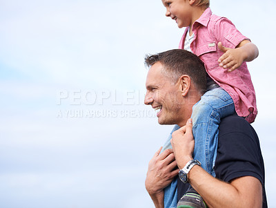 Buy stock photo Father, outdoor and carrying son on shoulders for childhood playing, sunshine and wellness by blue sky. Parent, child and happiness in nature for bonding together, love and fun on outside on vacation
