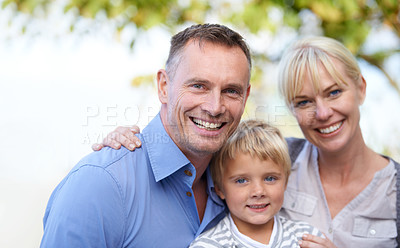 Buy stock photo A cute young boy flanked by his parents outdoors
