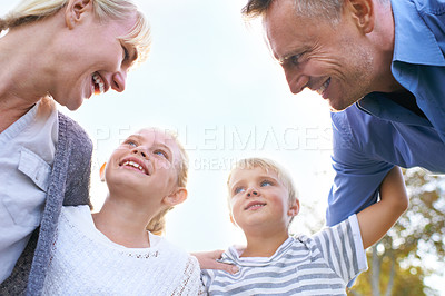 Buy stock photo Happy, parents and children embrace in garden outdoor in summer with love, freedom and huddle on blue sky. Below, family and support kids with smile in backyard at home with mother and father