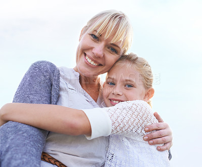 Buy stock photo Mother, daughter and portrait with hug outdoor for bonding, holiday or vacation memories with blue sky. Family, woman and girl child with embrace for relationship, love and care in nature with smile