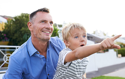 Buy stock photo Bonding, father and child in garden pointing with excited, smile and outdoor view in backyard. Happy man, son and quality time together in neighborhood with learning, discovery and support from dad.