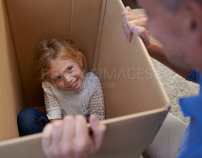 Buy stock photo Moving, playing and girl in box with dad, fun in new home and happy package in apartment. Smile, father and playful child in cardboard with games, hiding and property investment for future family.