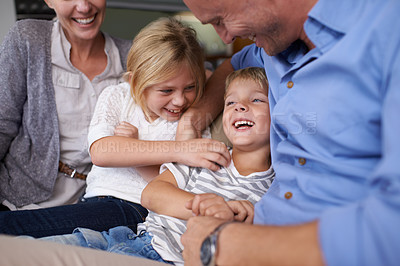 Buy stock photo A happy little boy laughing while spending time with his family