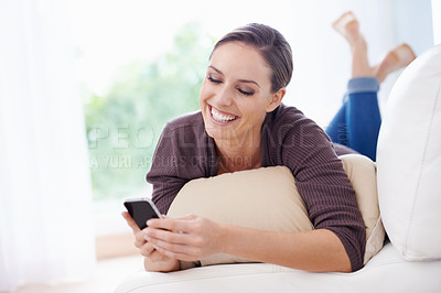 Buy stock photo Happy, woman and phone for typing on sofa, scroll social media and reading chat notification in lounge at home. Lady, relaxing and download digital app, mobile games and search contact on smartphone 