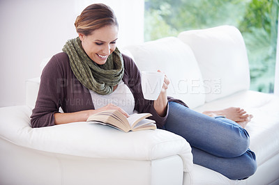 Buy stock photo Happy woman, book and reading with coffee on sofa for story, novel or knowledge in living room at home. Lady, fiction books and drinking cup of tea for literature, hobby or comfortable break on couch