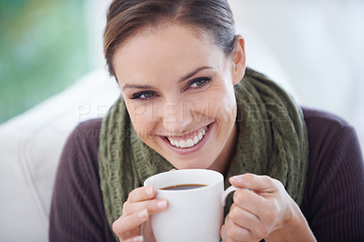 Buy stock photo A young woman smiling happily while holding a cup of coffee - closeup
