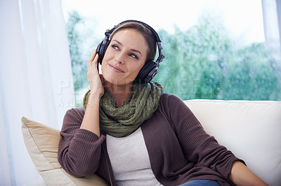 Buy stock photo Home, thinking and woman with headphones, listening to radio and peaceful with weekend break and calm. Apartment, podcast or person on sofa and headset for audio and streaming music with joy or smile