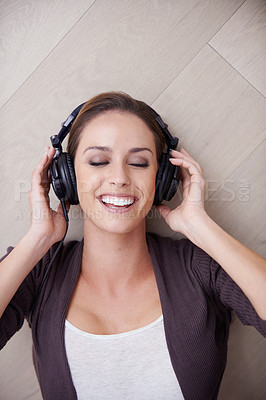 Buy stock photo Woman, relax with headphones and top view, listening to music with smile at home, album or playlist online. Podcast, radio and audio streaming, happiness with technology and peace with eyes closed
